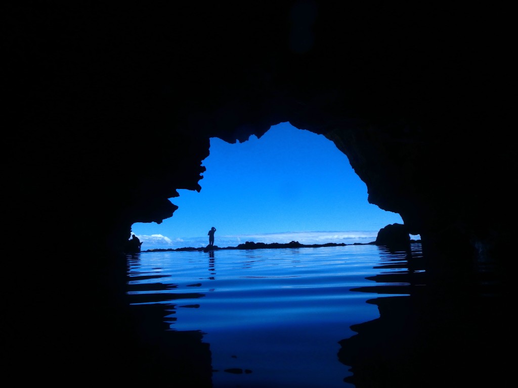 Drop In - Karen is backlit by the sky as she prepares to drop into this cave pool.